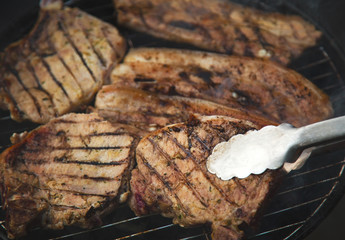 Grilled steaks on barbecue