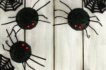 Halloween spider cupcake corner border on white wood
