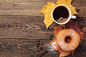 Donut, coffee and autumn leaves