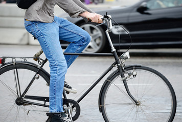 Young adult man in traffic on bike