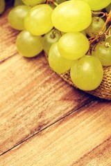 Closeup of white grapes,against oak wooden barrel.