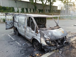 Burned car after street fight