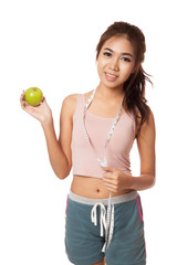 Asian slim girl with measuring tape and green apple