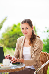 Portrait of a pretty young woman working on her computer