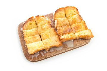 Bread toast and condensed milk on wooden plate