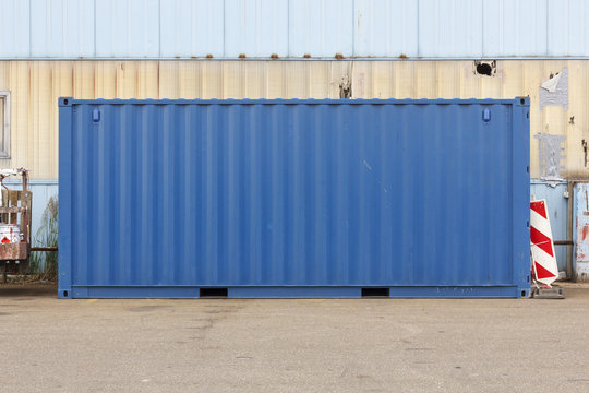 Unmarked blue shipping container.