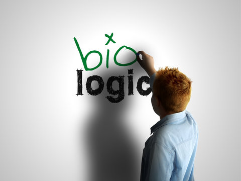 Bio logic. Boy writing on a white board