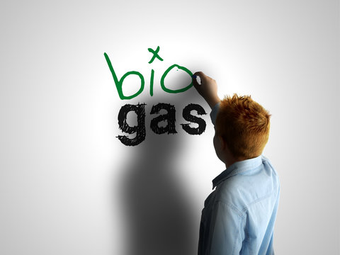 Bio gas. Boy writing on a white board