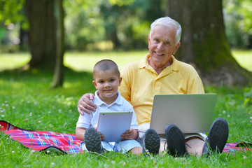 grandfather and child using laptop