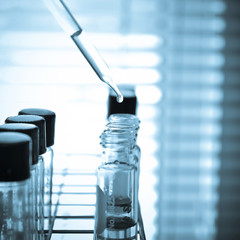 Laboratory research, dropping liquid to test tube