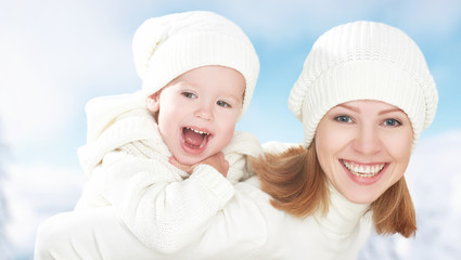 happy family on winter walk. Mother and baby daughter