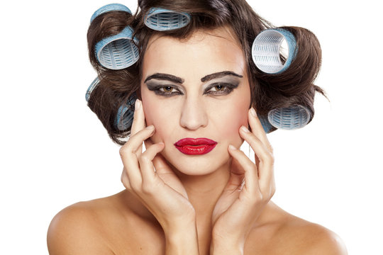 Funny woman with curlers and bad makeup