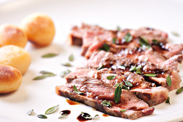 Sliced steak with potatoes