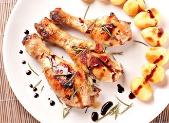Roast chicken with potatoes on a plate