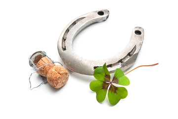 Horseshoe and champagne cork with a four leaf clover