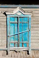Fototapeta na wymiar Aged wood window painted in blue colour