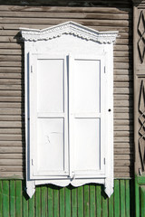 Old wooden window painted in white color