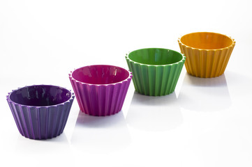 Four colorful cups over white background