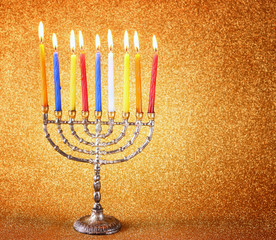 menorah with candels and glitter lights background. hanukkah con