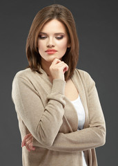 Casual style young woman posing on isolated studio background.