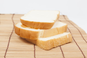 Sliced ​​bread on the wooden plate.
