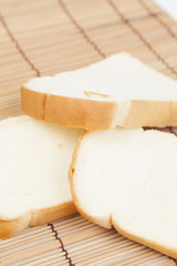 Sliced ​​bread on the wooden plate.