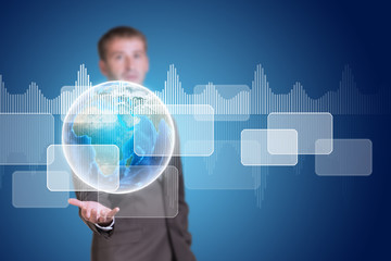Businessman hold Earth with transparent rectangles and graphs