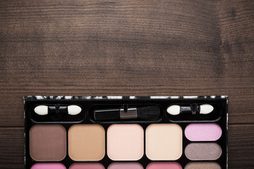 white make-up brushes on wooden background