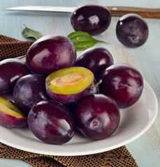 Plums on  white plate