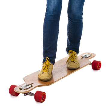 Skateboarder standing on a longboard