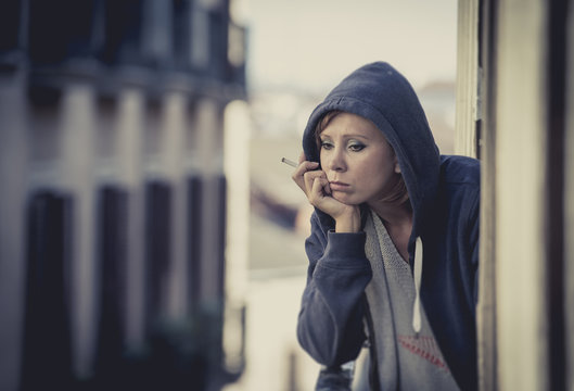 young woman suffering depression and stress at home balcony