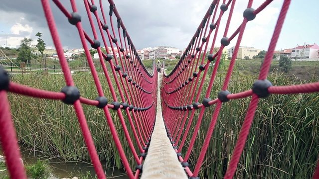 Man running through a stringed Bridge