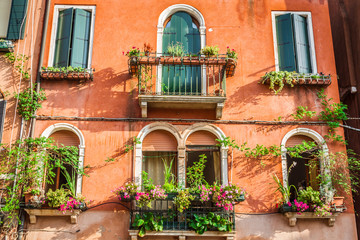 Fototapeta na wymiar Buildings with traditional Venetian windows in Venice, Italy