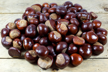 Chestnuts from an Autumn Harvest on an Old Rustic  Wooden Table