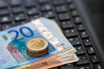 Money on keyboard of computer