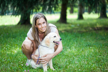 Smiling girl holding her dog