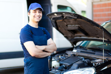 Smiling car mechanic at work