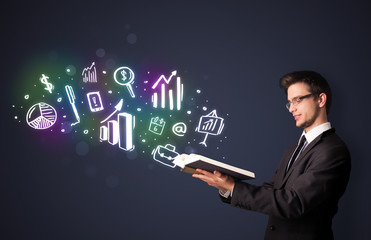 Young guy reading a book with business icons
