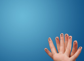 Happy smiley face fingers looking at empty blue background copy