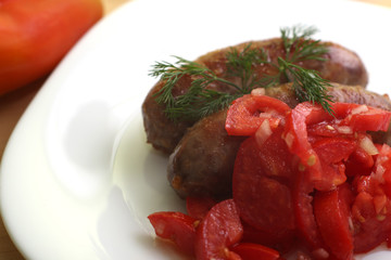 bratwurst with tomatoes and herbs
