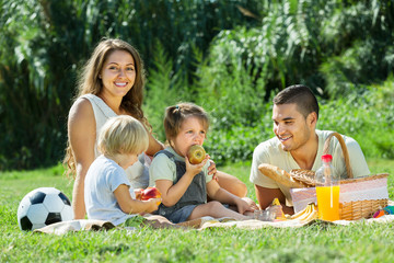 Fototapeta premium parents with daughters having picnic