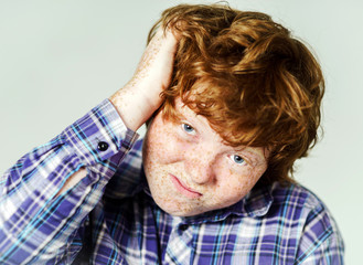 Emotional portrait of red-haired boy