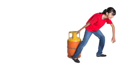 Young Asian girl moving an old cooking gas propane cylinder 