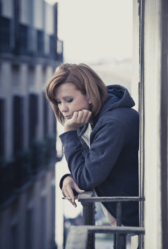 young woman suffering depression and stress at balcony