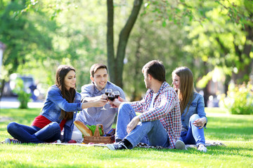 Fototapeta premium Happy friends on picnic in park