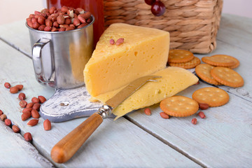 Cheese and crackers on wooden table close-up