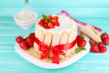 Tasty cake Charlotte with fresh strawberries on wooden table