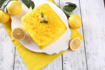 Tasty lemon cake on wooden table