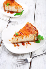 Cheese cake in plate on grey wooden background