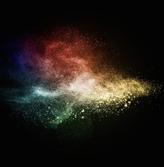 Colourful powder exploding isolated on black